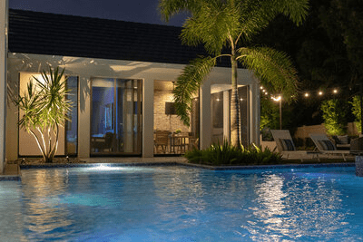 Gorgeous home and pool with landscape and string lighting 
